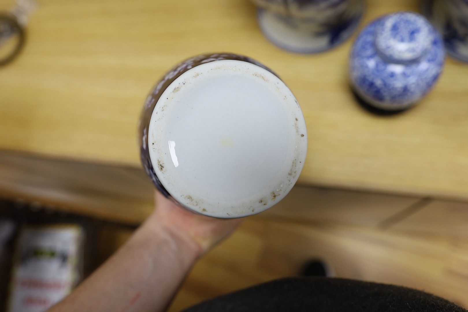 A pair of Japanese black ground vases, a pair of Chinese blue and white vases and covers, a similar pair of jars and a vase, four wood stands. Largest 41cm